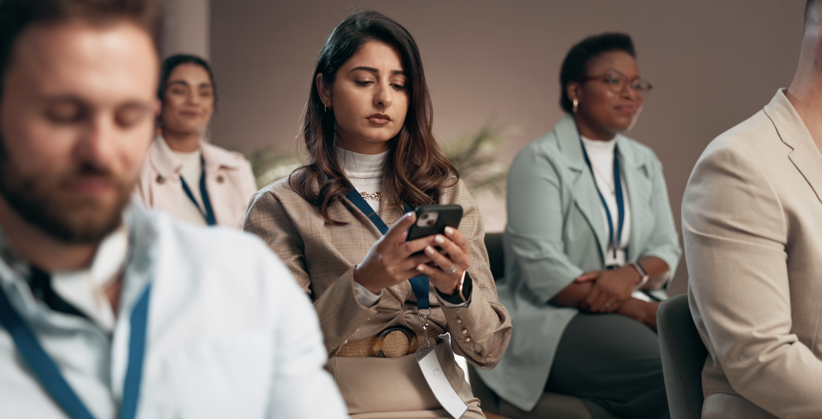 An attendee checking the Jybe app on her phone at a conference